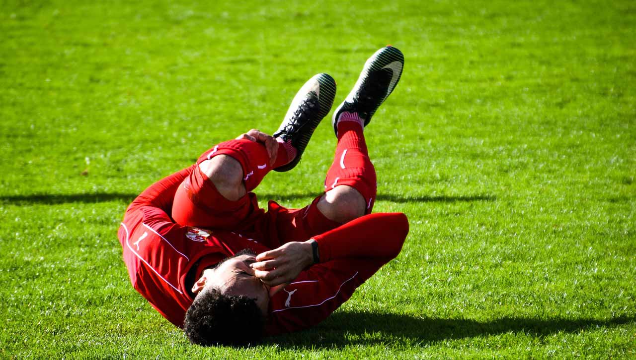 Football Player With Muscle Cramp