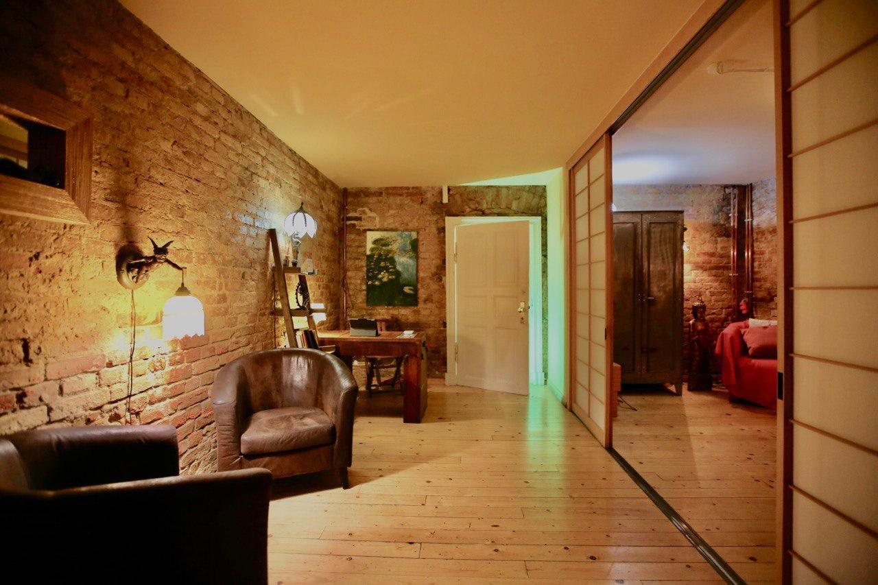 The reception room at Northern Holistic: exposed brick, leather armchairs and warm lamplight